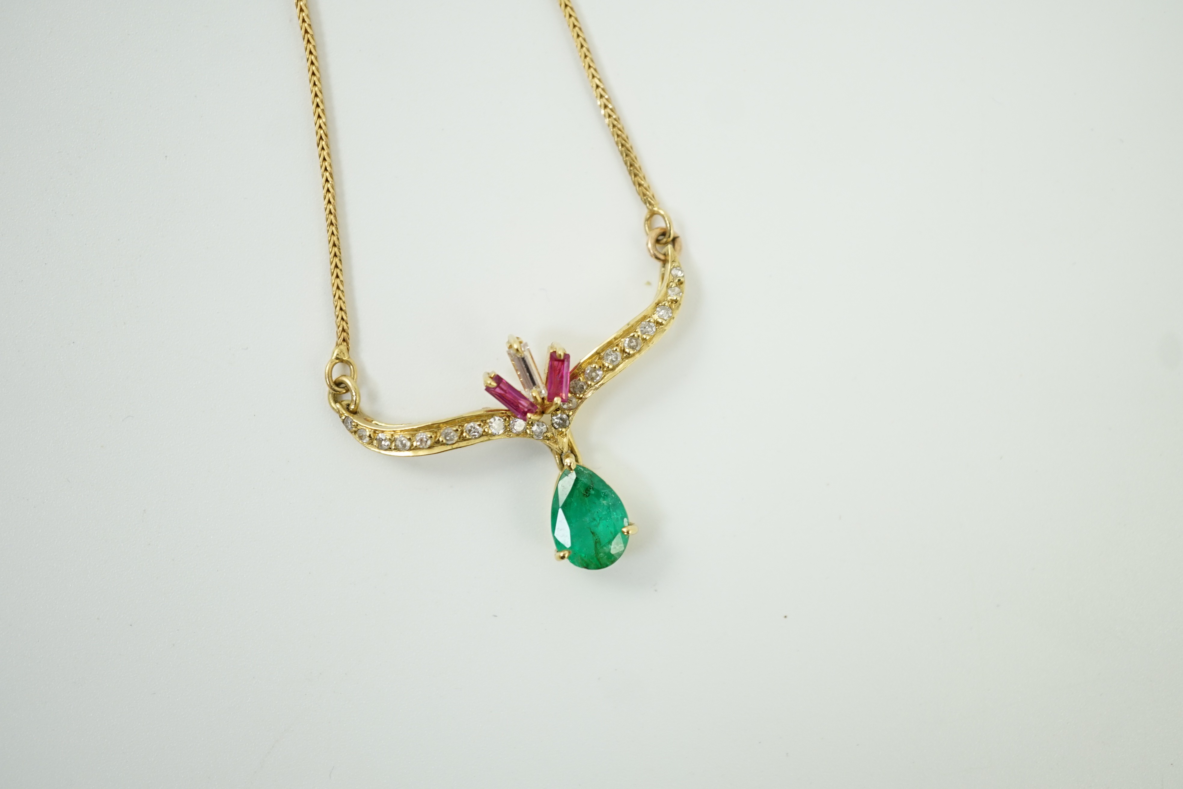 A modern Italian 750 yellow metal, emerald, ruby and diamond cluster set drop pendant, pendant width 35mm, chain 34mm, gross weight 7.3 grams.